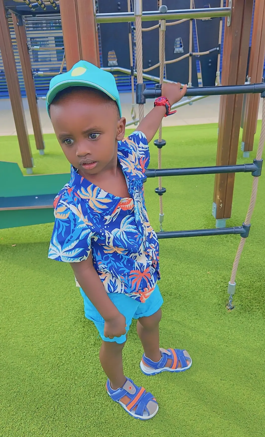Ethan Rurangwa playing on a playground climbing frame
