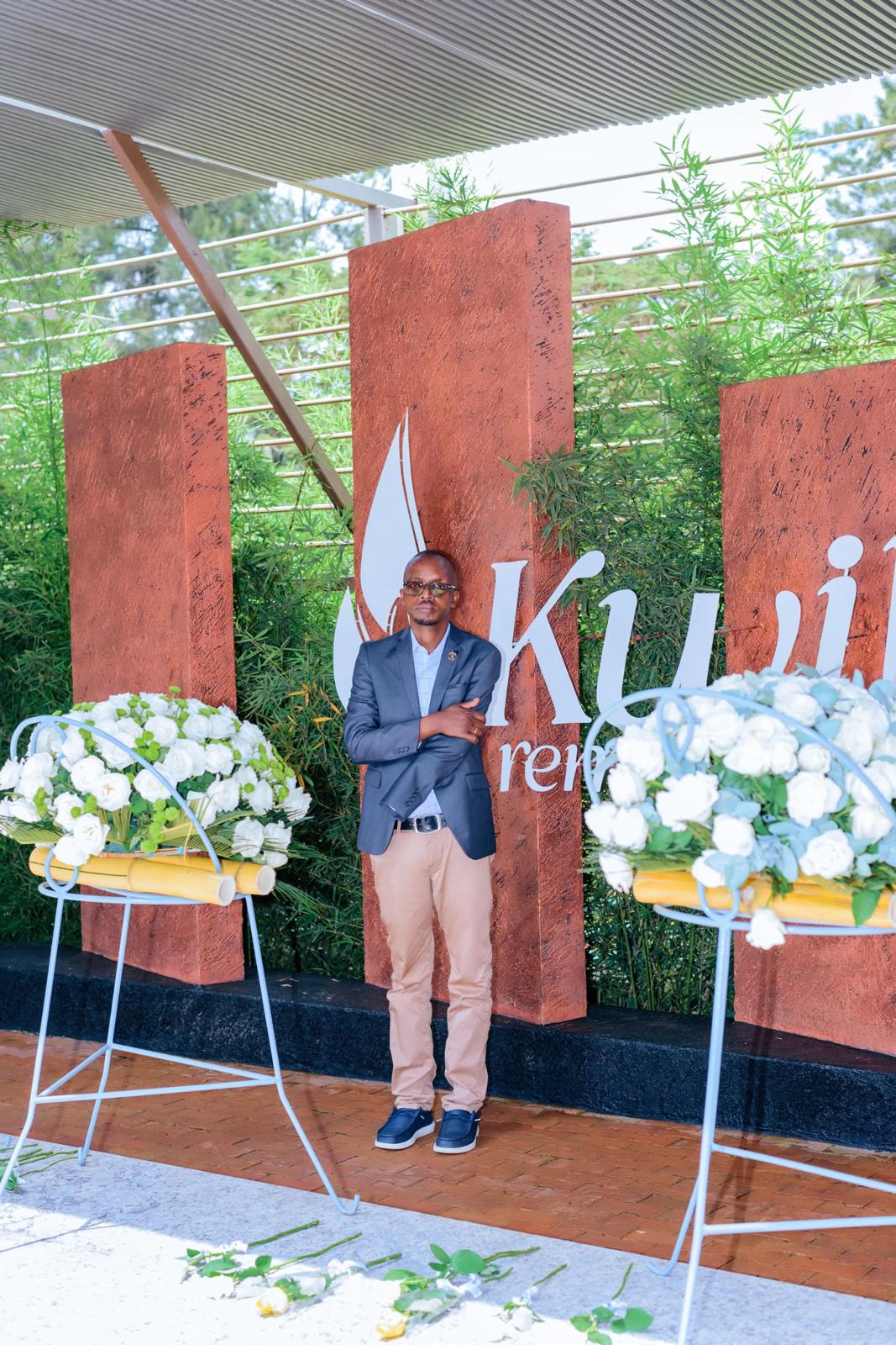 Révérien Rurangwa at the Kigali Genocide Memorial, beside wreaths of white flowers